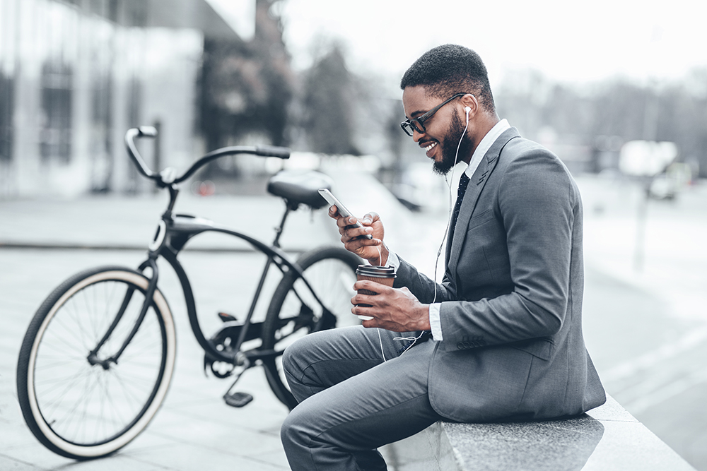 man in suit with bike and phone