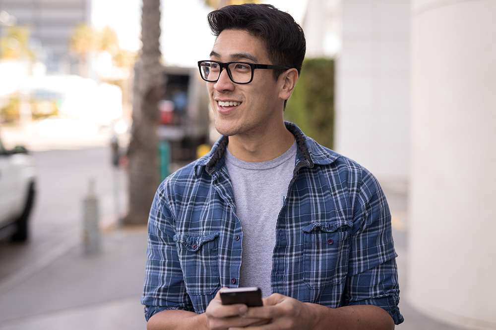 man waiting for a car with phone